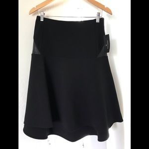 Women’s black knee flowy skirt with leather.